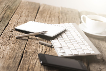 Office concept. Keyboard, tablet pc, and coffee on old wooden table