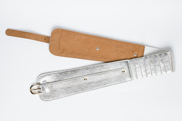 Women's silver leather belt on a white background