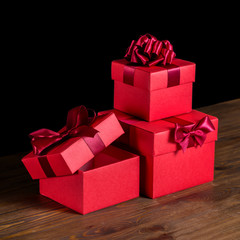 festive opened boxes with bow on wooden background is isolated,