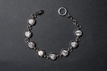 silver bracelet with diamonds on a black background