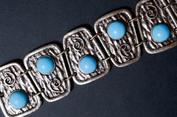 silver bracelet with blue stones on a black background