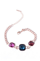 gold bracelet with colored stones on a white background