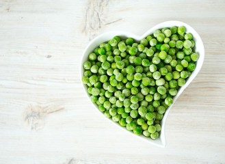 frozem peas on wooden surface