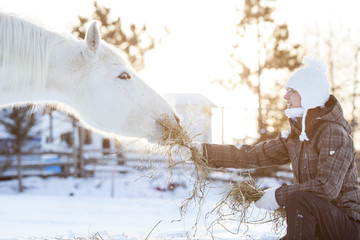 Young  woman with horse winter sport