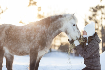 Young  woman with horse winter sport