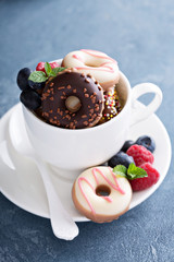 Small mini donuts in stacked coffee cups
