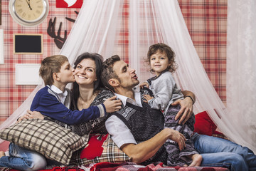 Family mum dad and kids together at home in the cosy atmosphere