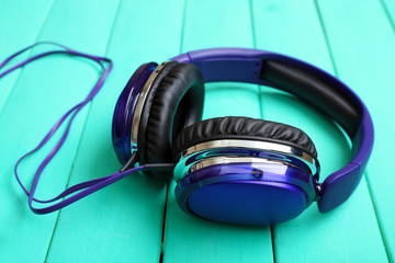 Headphones on wooden background