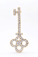 brooch in the form of a key on a white background