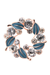 round brooch with leaves on a white background