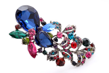 brooch with colored stones on a white background