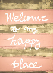 Concept image of Welcome to my Happy Place motivational quote hand written on vintage painted wooden wall