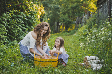 Fototapeta premium Daughter with mother washing clothes in nature 4706.