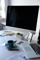 Workplace with computer and laptop on the table