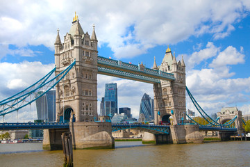 Fototapeta na wymiar LONDON, UK - APRIL 30, 2015: Tower bridge and City of London financial aria on the background. View includes Gherkin and other buildings