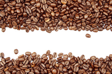 Roasted brown coffee beans on white background. Copy space