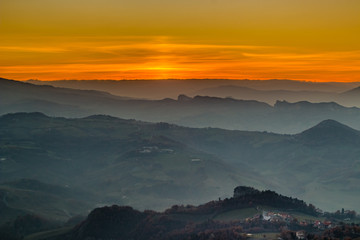 sunset on hilltops in the mist