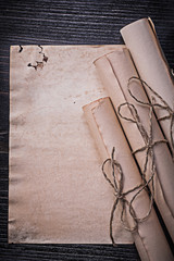 Vintage corded paper scrolls on wooden board