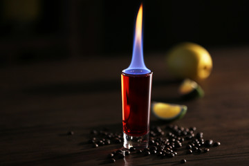 Burning cocktails with lime and coffee beans on a table