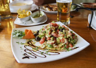 Fresh vegetable salad with octopus. Appetizer closeup