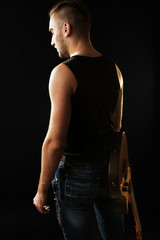 Young man  with electric guitar close up