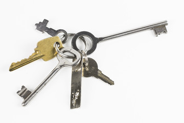 Six metal keys of different shape on white background