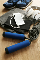 Sport clothes and equipment on wooden background