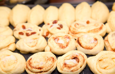 Buns with raisin and cinnamon before baking, a fragment of a big