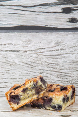 Portions of delicious homemade blueberry sponge cakes over wooden background