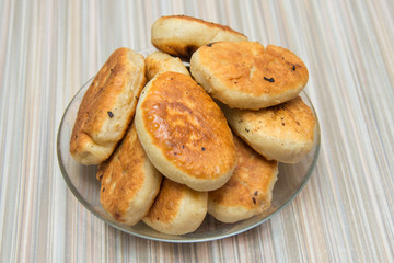 Fried pies on a plate lying on a table