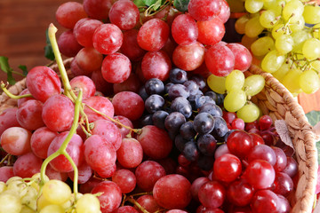Naklejka na ściany i meble Grape in basket on wooden table, closeup