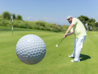 Man playing golf at club