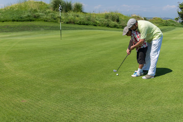 Fototapeta premium Man playing golf at club