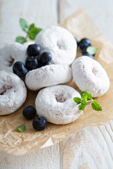Powdered sugar donuts on parchment