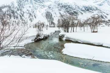 Snowy fields near stream, Italy, Alps, Piemonte, Alpe Devero