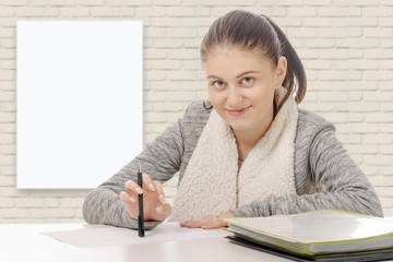  young woman writing on her desk