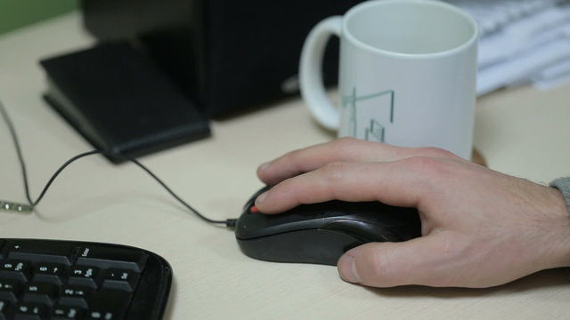 A Man Is Using Mouse To Manipulate Computer