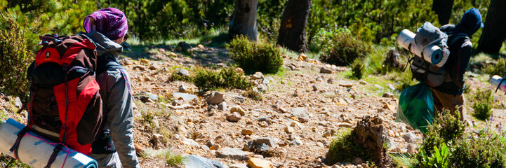Girl and man Hikers with backpacks Trecking Down The Mountain Tajamulco