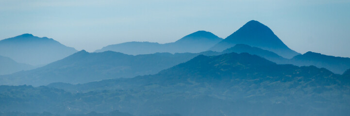Skyscape of cold blue mountains with mist and fog close to Quetzaltenango