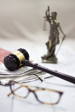Law concept, statue, gavel, newspaper and glasses