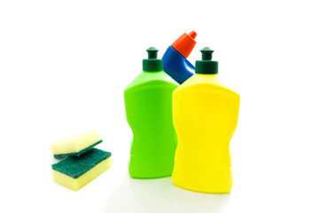 three bottles of detergent and sponges