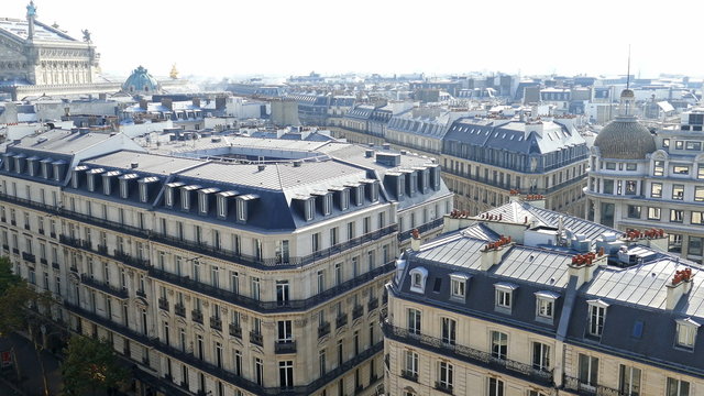 Aerial view from the terrace of store Printemps, with roofs and Madelaine church.
