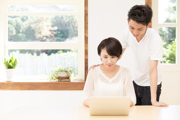 young asian couple using laptop