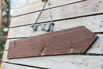 Blank wooden signboard hanging on a rope