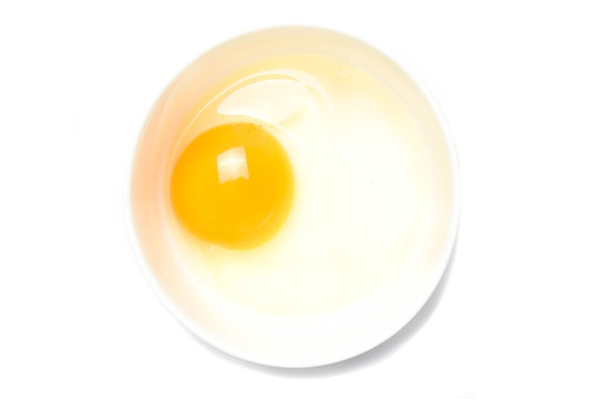 raw eggs in a white bowl on white background