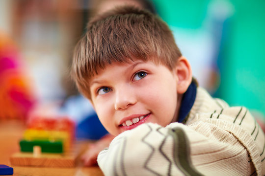 portrait of young smiling boy, kid with disabilities