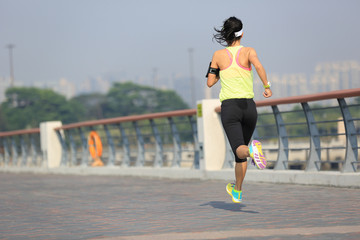 Fototapeta premium young fitness woman runner running at seaside