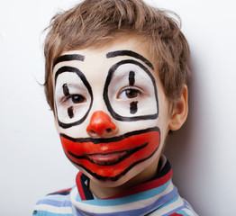 little cute boy with facepaint like clown, pantomimic expressions close up