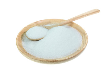 Close up of white sugar in wooden bowl isolated on white