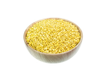 Close up peeled split mung bean in wooden bowl isolated on white